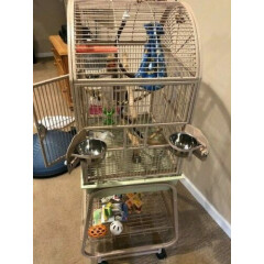 Bird cage with stand. Overall 18 x 24 x 53 dome top beige. Includes toys shown