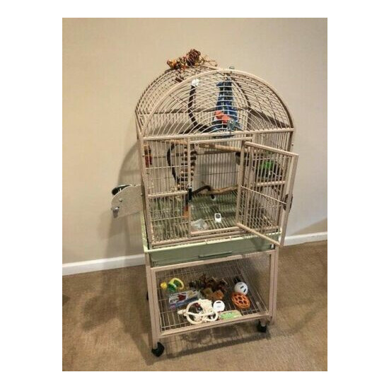 Bird cage with stand. Overall 18 x 24 x 53 dome top beige. Includes toys shown image {1}